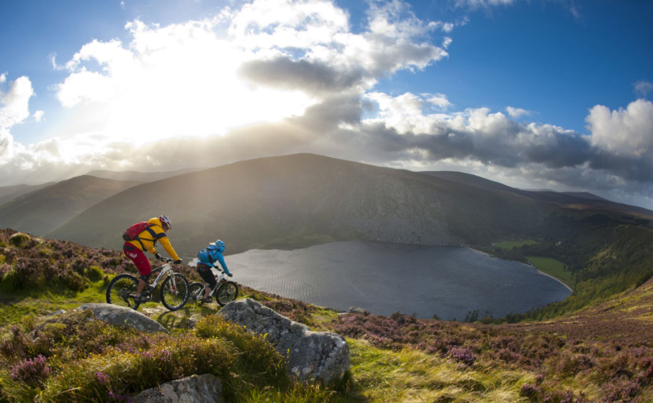 two-people-cycling-on-hill